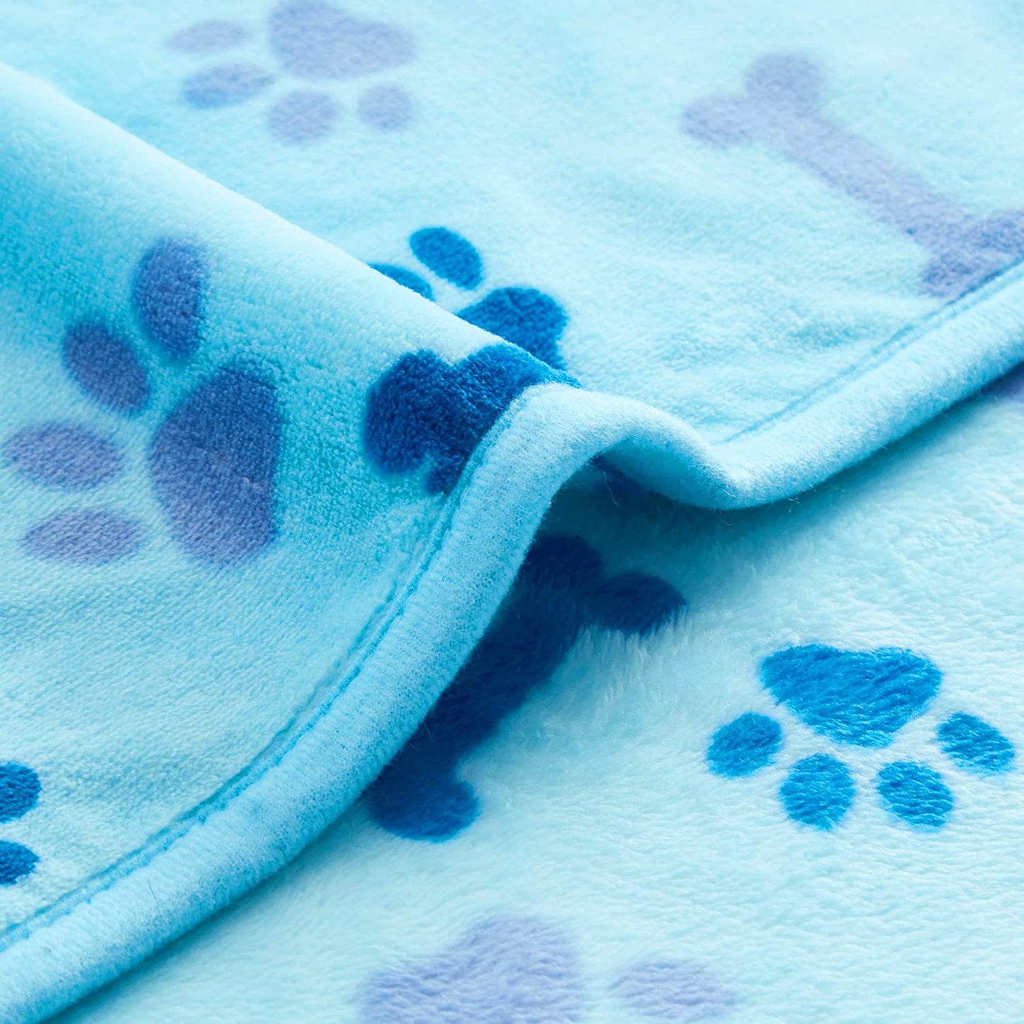 "Cozy and Stylish Blue Paw and Bone Dog Blanket - The Ultimate Luxury for Your Beloved Pet!"